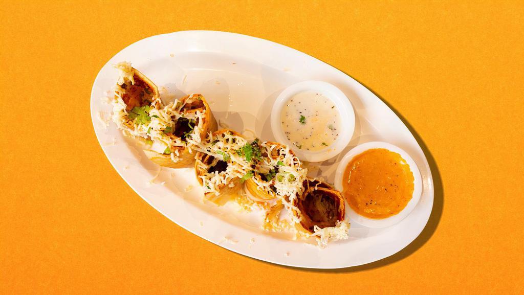 Indo-Chinese Lentil Crepe · Dosa filled with mixed vegetables served with lentil soup, coconut, and tomato relish.