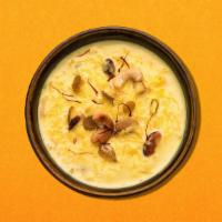 Rice Pudding · Rice pudding cooked with milk and topped with nuts and saffron.