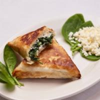 Spanakopita · Layers of phyllo dough stuffed with feta cheese and spinach.