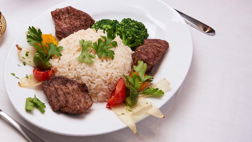 Beef Kabab · Professionally cut, seasoned, and grilled chunks of beef kabab served on a bed of rice and your choice of sauce.