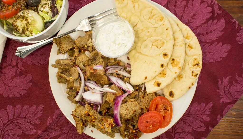 Gyro Plate · Gyro strips, served with onions, tomatoes, pita bread or rice, and your choice of sauce.
