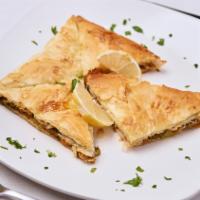 Gulaash · Baked layers of phyllo dough with a middle layer of lamb, beef, and vegetables.
