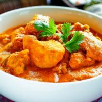 Tika Masala · BBQ chicken cubes cooked in red creamy sauce with fresh herbs and spices.