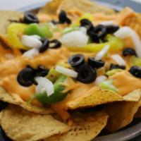 Small Nacho Sup · Fresh and crispy tortilla chips made in house and covered in our seasoned ground beef, melte...