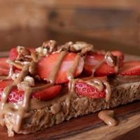 Almond-Strawberry Toast · Organic sprouted bread, organic almond butter, strawberry, pecan and honey
