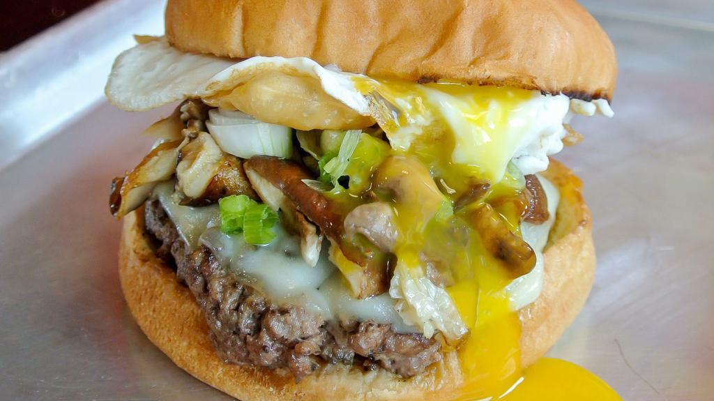 Samurai · 8 ounce char grilled patty with spices of the orient, sautéed shiitake and button mushrooms with green onions, melted provolone cheese crunchy fried wonton and a fried egg with spags samuri sauce on a toasted brioche bun.