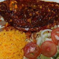 Mojarra · Whole fried tilapia served with salad, tortillas, rice and beans.