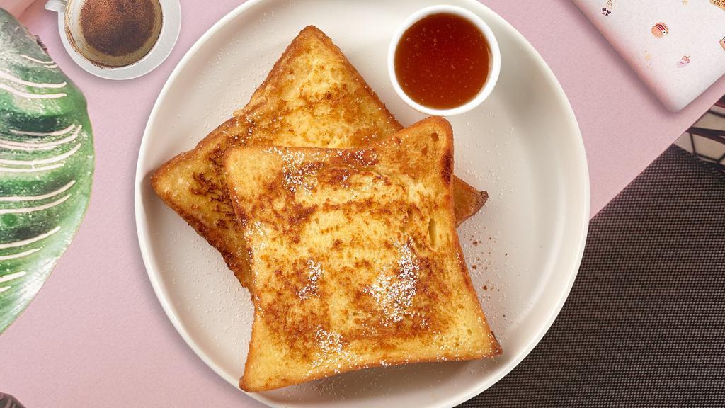 Frenchy French Toast · Fresh bread battered in egg, milk, and cinnamon cooked until spongy and golden brown. Topped with powdered sugar, and served maple syrup.