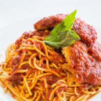 Chicken Parmigiana · Breaded chicken cutlets served over spaghetti and marinara sauce, topped with 4 cheese blend...