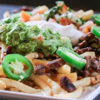 Carne Asada Fries · Steak and bacon on top of French fries, melted cheese, and our signature cheese sauce, toppe...