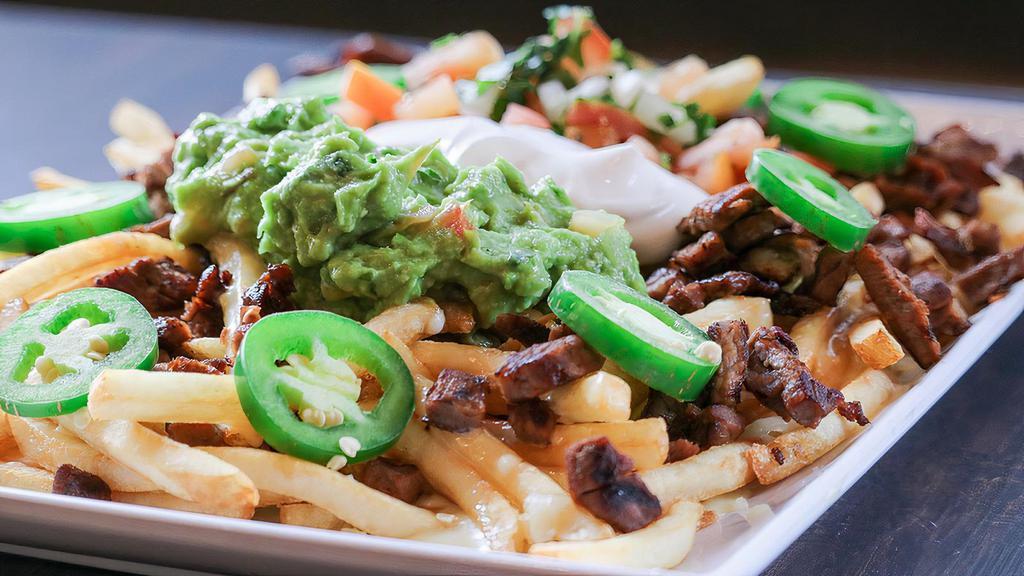 Carne Asada Fries · Steak and bacon on top of French fries, melted cheese, and our signature cheese sauce, topped with sour cream, pico de gallo, guacamole, and fresh jalapeños.
