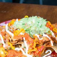 Replay Nachos · Pepper jack cheese, guacamole, roasted tomato salsa, Pico de Gallo, pickled peppers and sour...