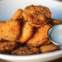 Breaded Fried Dill Pickles · Panko and cornmeal breaded fried dill pickles with buttermilk ranch dressing.