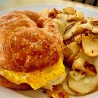 Breakfast Croissant (Dd) · Two eggs over hard with your choice of ham, bacon or sausage patties inside a grilled butter...
