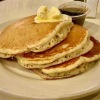 Gc Pancakes (Dd) · three fluffy made from scratch buttermilk pancakes with whipped butter and maple syrup, serv...