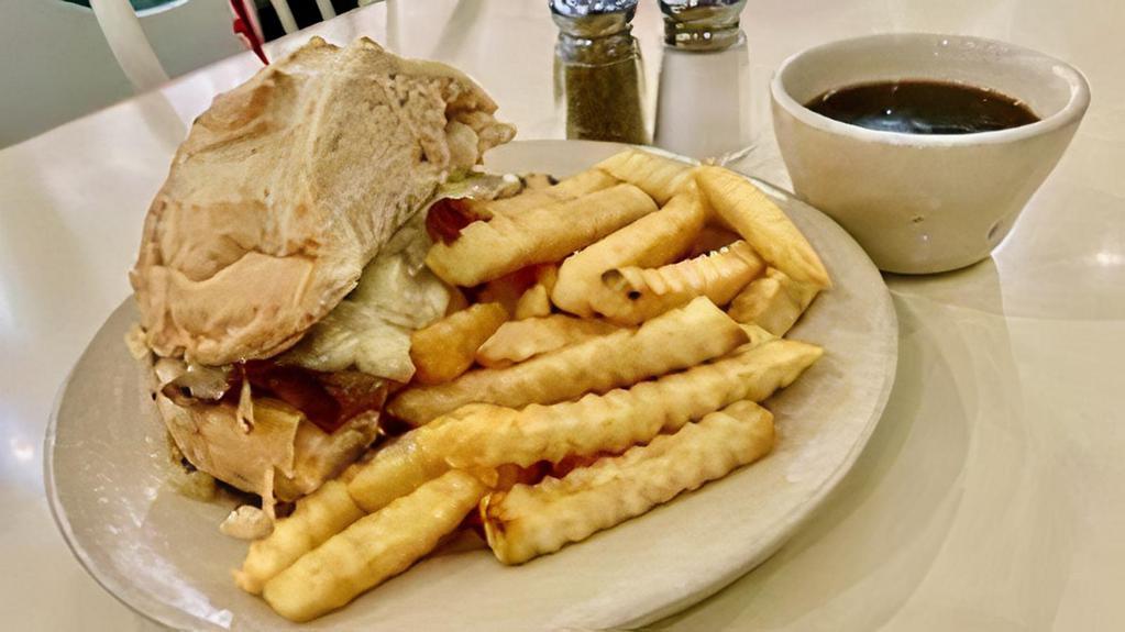 French Dip · thin sliced roast beef, julienned white onion, Swiss cheese, sourdough, served au jus, served with French fries
