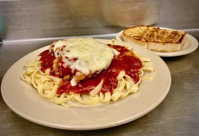 Chicken Parmesan · “freshly breaded” and topped with marinara and mozzarella cheese, served with your choice of pasta, and a slice of grilled garlic toast