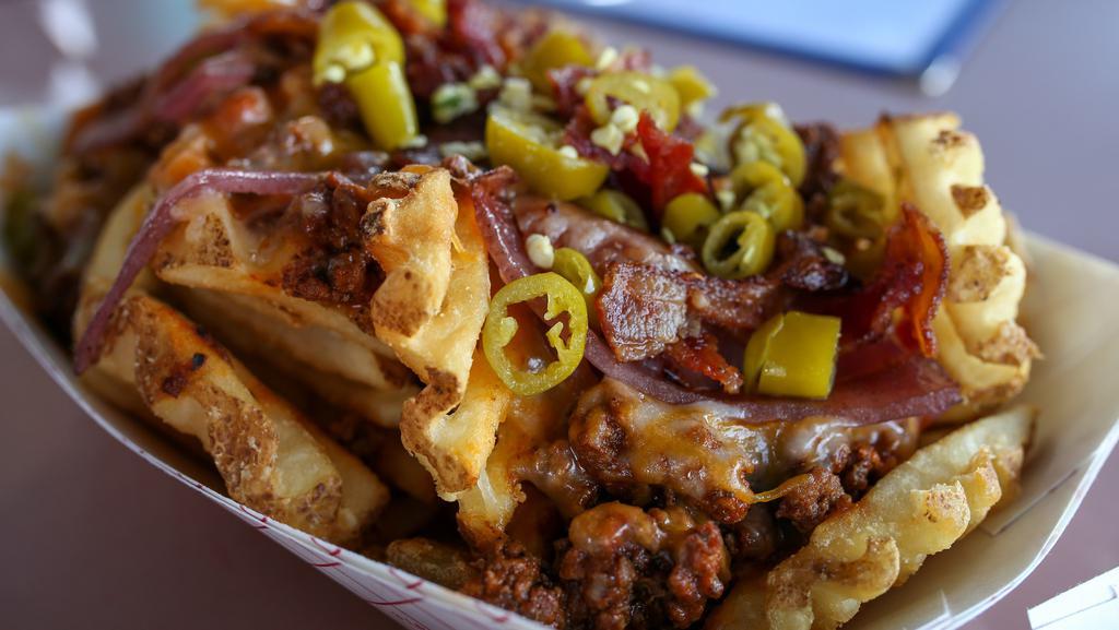 Loaded Waffle Fries · Waffle fries, chili, cheddar, grilled onions, bacon, sport peppers. Add eggs for an extra cost.