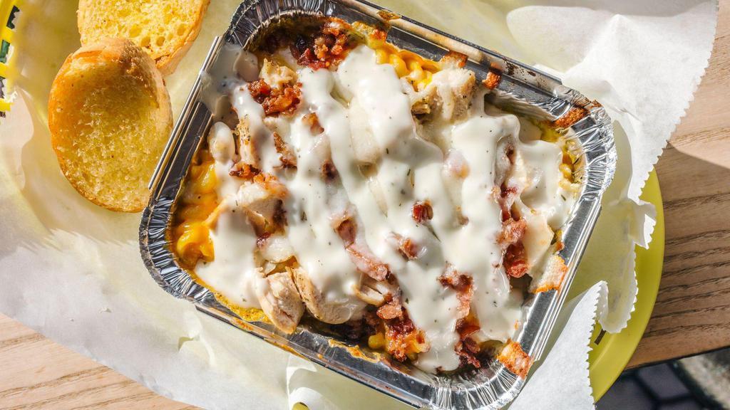 Medium Chicken Bacon Ranch Mac  N Cheese By Joey'S G Mac N Cheese · By Joey G's Mac n Cheese. Cheddar, mozzarella and seasoned baked chicken breast. Topped with bacon, ranch dressing and seasoned breadcrumbs. Served with 2 slices of Garlic Bread. Contains gluten, sesame, dairy, soy, and eggs. We cannot make substitutions.