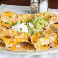 Nachos · An enormous pile of fresh tortilla chips heaped with Monterey Jack and cheddar cheeses, refr...