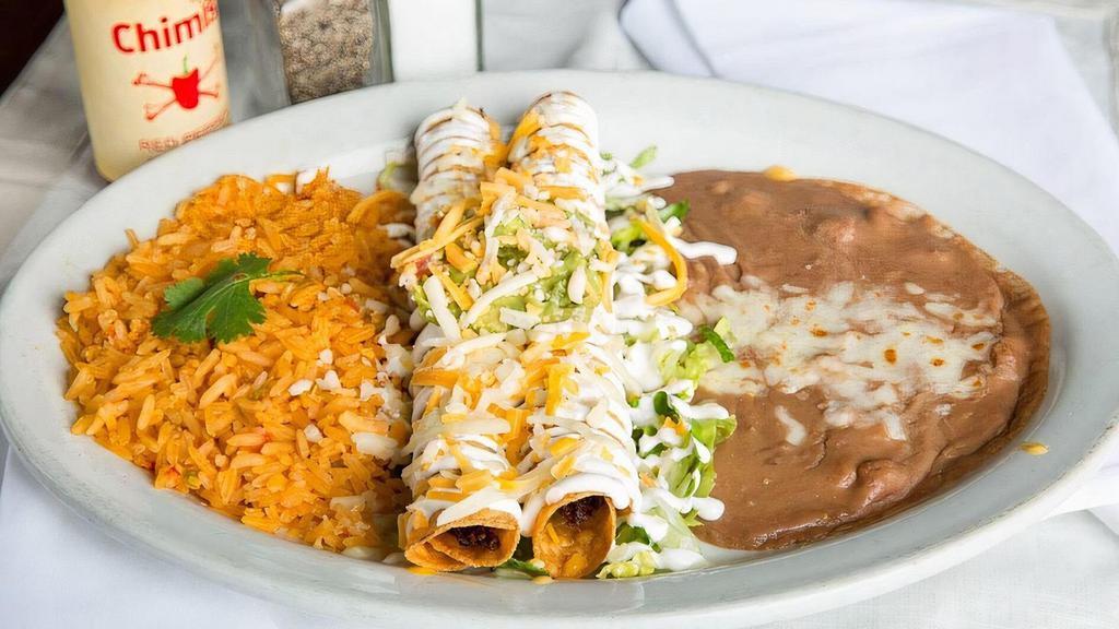 2 Flautas · Shredded beef or shredded chicken rolled in con tortillas, fried and topped with our fresh guacamole, sour cream, cheddar and Monterey Jack cheeses.