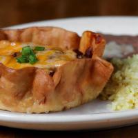Tamale Pie Dinner · Our unique and famous tamale pie is a crispy flour tortilla bowl filled with a fresh tamale,...