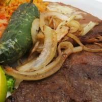 Ribeye Carne Asada · Tender thin sliced ribeye steak served with pico de gallo, caramelized onions, jalapeños and...