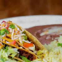 2 American Tacos · Crispy corn tortilla shell filled with ground beef, shredded beef or shredded chicken and to...