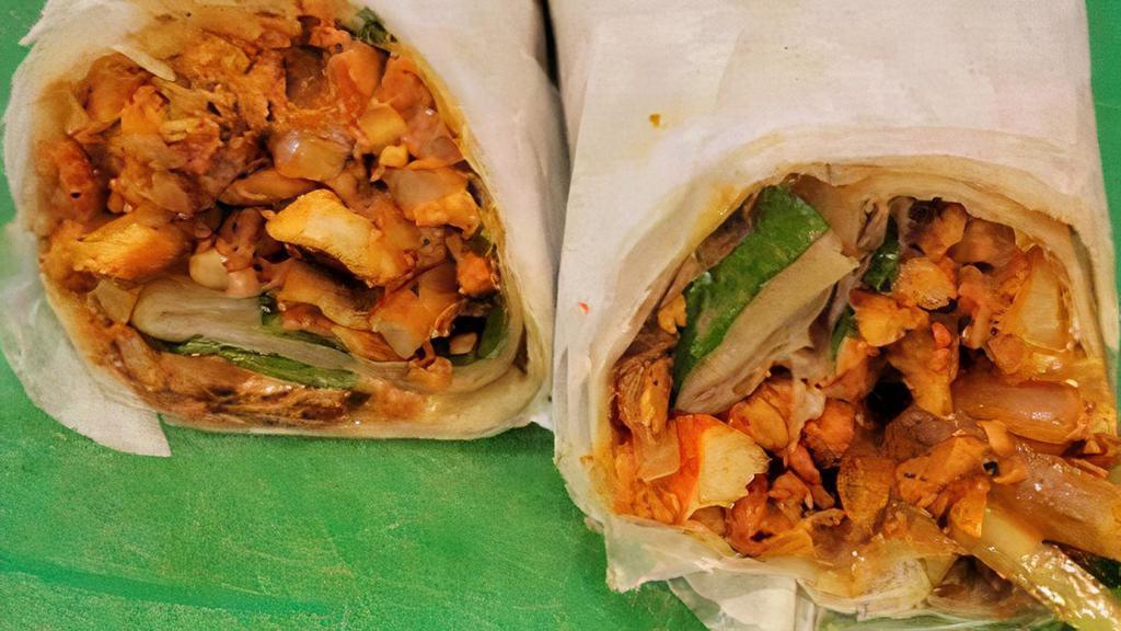 Chicken Burrito · Seasoned Chicken Grilled with Onions , Potatoes, Green Peppers and Mixed Vegetables then Grilled together with a little Rice, Spinach and Beans finished off with cheez we finally wrap it on a toasted Tortilla