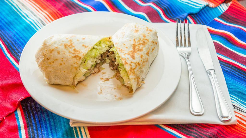 Veggie Burrito · A giant flour tortilla filled with refried beans, sour cream, lettuce, tomatoes, cheese, and avocado.