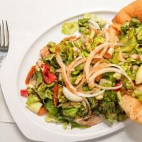 Fattoush Signature Salad · A fried pita bowl filled with fresh romain mixed lettuce, tomatoes, cucumbers, green peppers...