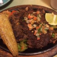 Carne Asada · Tender beef rib - eye cooked with tomatoes, onions and bell peppers. Served with guacamole s...