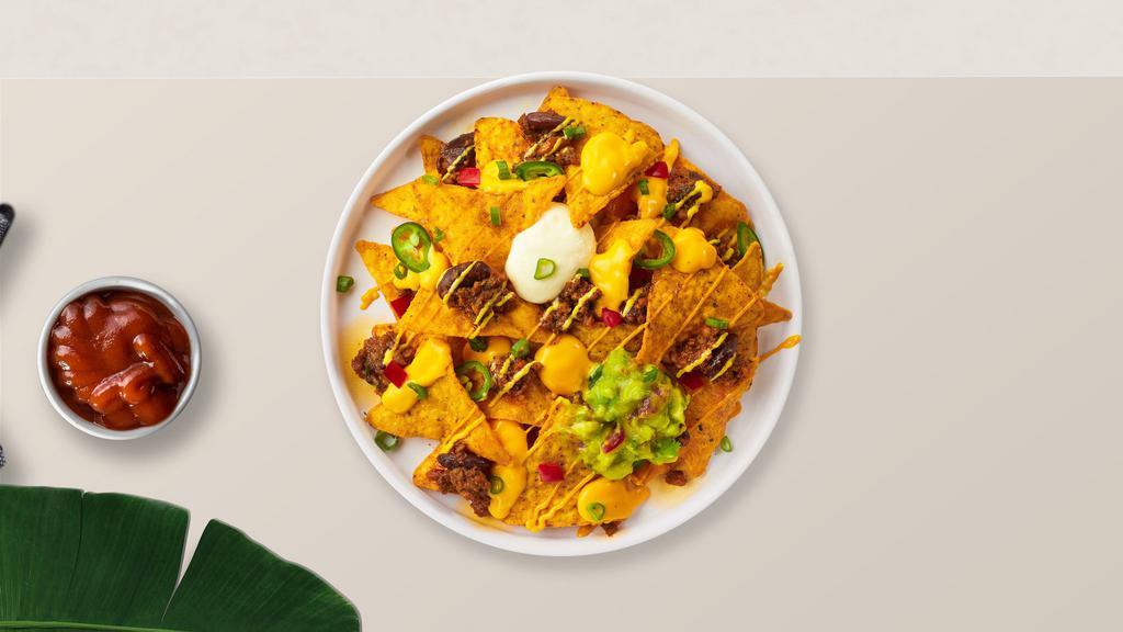 Nacho Supreme · Salted tortilla chips doused in melted nacho cheese and topped with ground beef, jalapenos, pinto beans, sour cream, and avocado.
