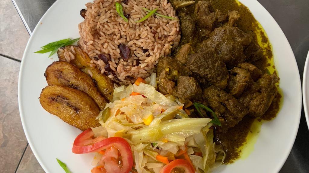 Curry Goat  · Jamaican style Curry Goat 
Served with Red Beans and Rice, cabbage and Plantains
