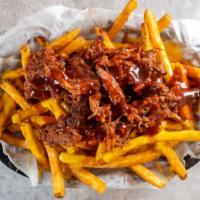 Ashley'S Fries · Smothered with nacho cheese, BBQ shoulder and mixed. Drizzled with BBQ sauce and topped with...