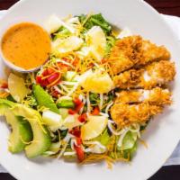 Coconut Chicken · Fresh lettuce mix topped with crispy coconut
chicken, red pepper, diced pineapple, avocado a...