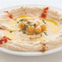 Hummus · A blend of ground chickpeas mixed with tahini, topped with olive oil & spices.