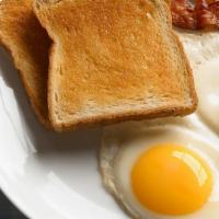 2 Eggs (Any Style) · Hash browns or fruit and toast or pancakes.