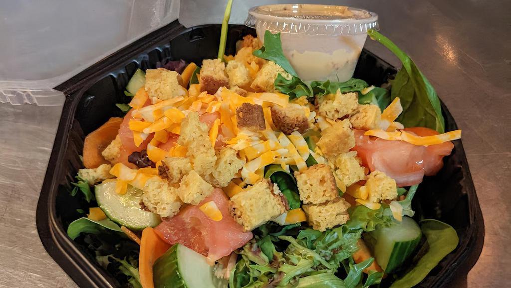 Simple · Mixed greens, sliced carrot, cheddar jack, cucumber, tomato, cornbread croutons, honey mustard dressing.