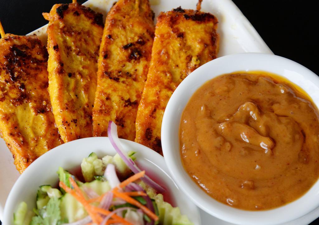 Chicken Sate (4 Sticks) · Marinated and char-broiled chicken breast served on sticks with peanut sauce and cucumber salad.