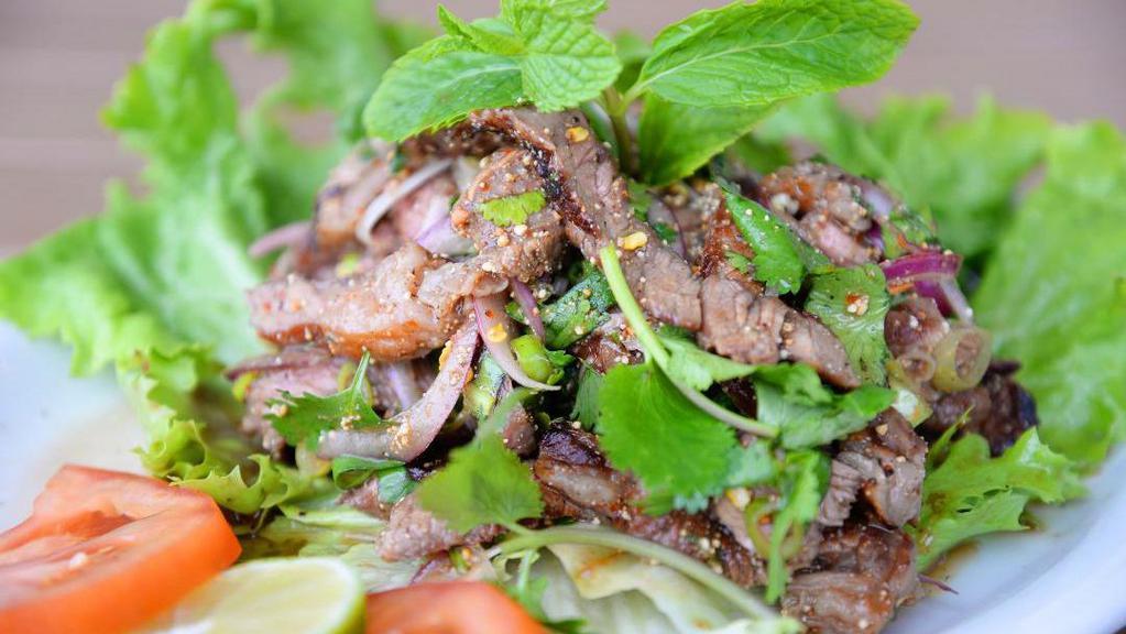 Bbq Beef Salad (Nua Nam Tok) (Spicy) · Grilled beef tossed in a chili lime dressing with roasted rice, red onions, mint leaves and cilantroes.