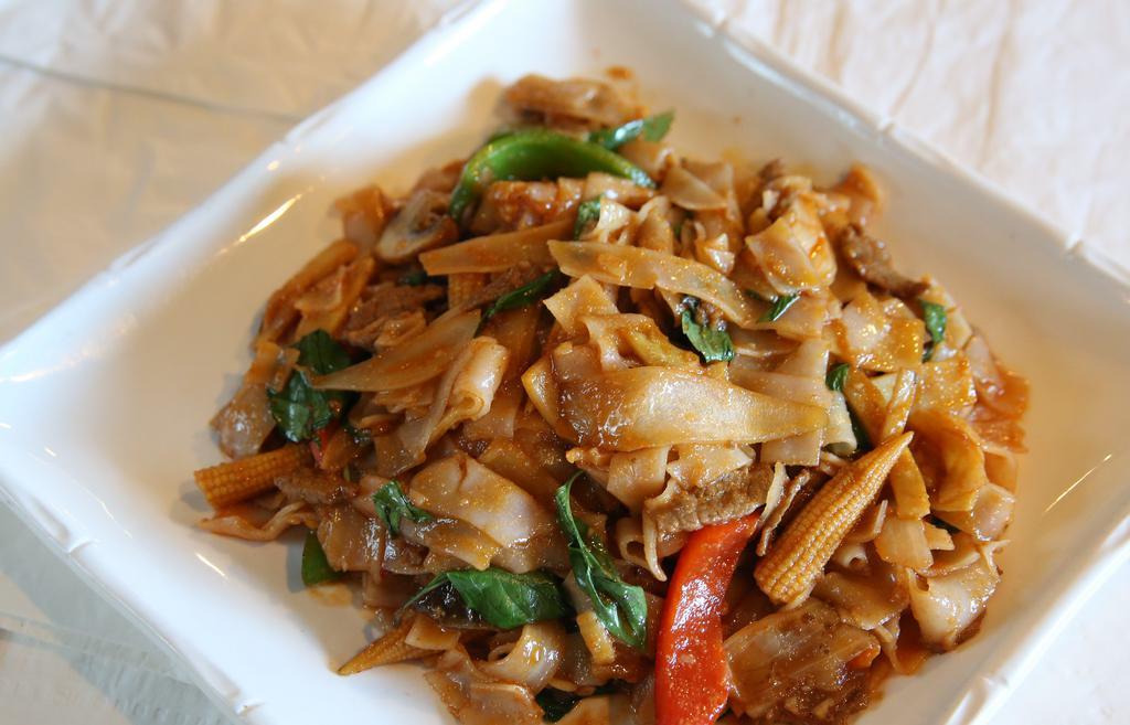 Spicy Basil Noodles (Pad Kee-Mao) · Flat noodles stir-fried with selected meat, seafood,  vege/tofu, basil, chili, mushrooms, bamboos, corns, bell, onions, soy sauce, spices.