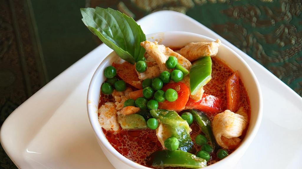 Panang Curry (Spicy) · Like red curry, Panang is made with coconut milk, basil, peas, bell peppers, and lime leaves.