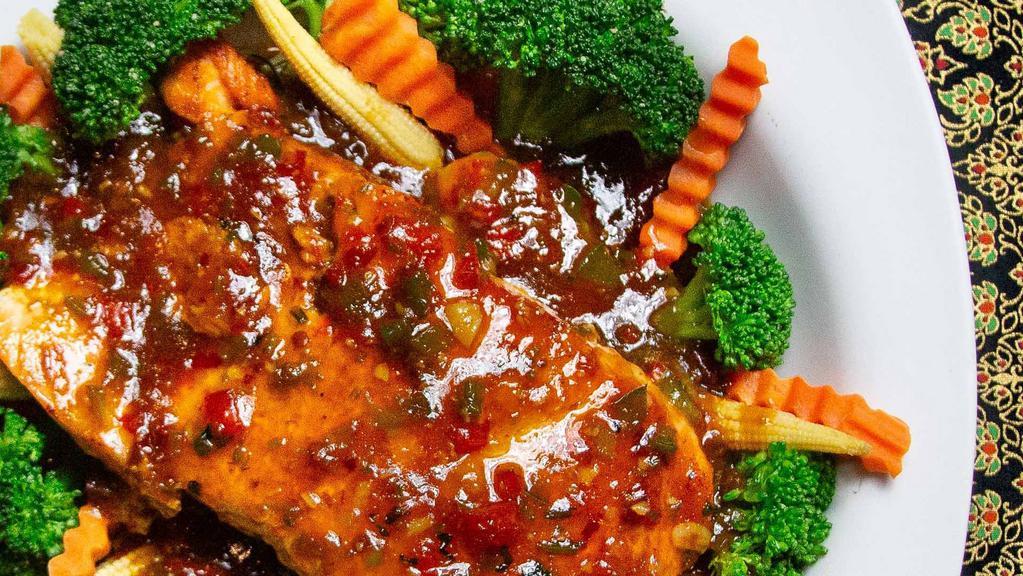 Four Seasons Salmon (Spicy) · Grilled salmon with onions, garlic, peppers in our house sweet & sour sauce served with steamed broccoli, zucchini, and topped with basil.