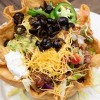 Taco Salad · Seasoned ground beef, mixed greens, chopped tomatoes, jalapenos, black olives, cheddar chees...