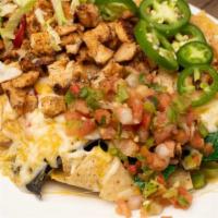 Ultimate Chicken Nachos · Layers of rainbow tortilla chips smothered with cheese sauce, guacamole, sour cream, jalapen...