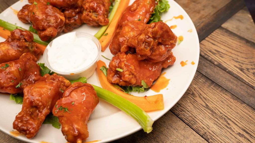 Buffalo Wings · Our jumbo chicken wings served breaded naked or boneless and tossed in anyone of our delicious sauce and served with our signature blue cheese dressing.