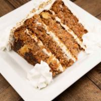 Carrot Cake · Carrot cake filled with nuts and raisins. Topped with a cream cheese frosting.