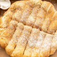 Warm Cinnamon Pene Bread · Thick and warm smothered in cinnamon and dashed with confectiners powerdered sugar, accompai...