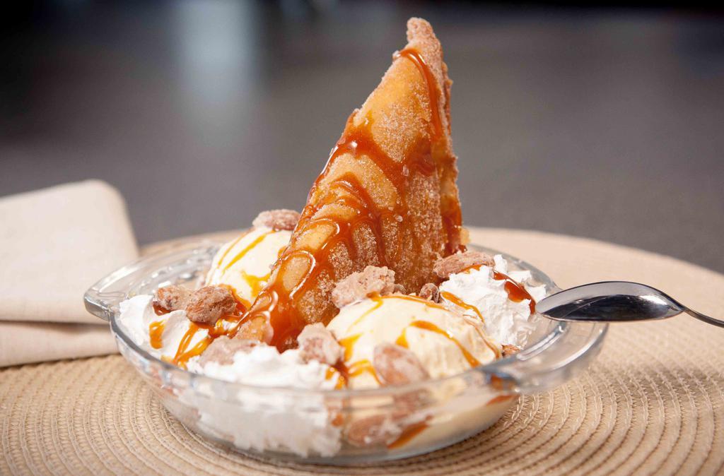 Salted Caramel Deep Fried Apple Pie · Rolled in cinnamon sugar, drizzled with salted caramel on top of vanilla ice cream with candied vanilla almonds.